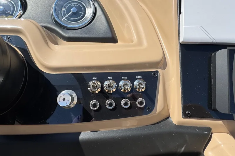 Slide: The Image of Control panel of 2026 Barletta Cabrio 24UE boat with switches and gauges. - 69