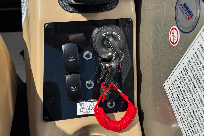 Slide: The Image of Control panel of 2026 Barletta Cabrio 24UE boat with ignition and canopy switches. - 73