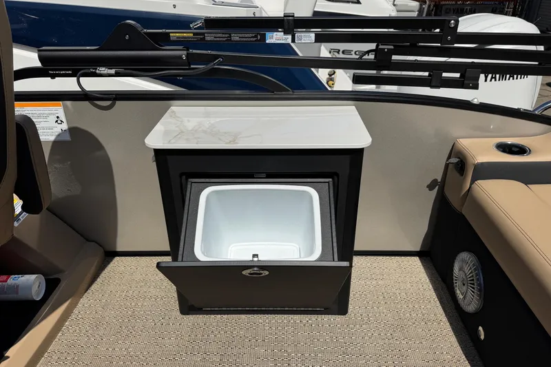 Slide: The Image of Barletta Cabrio 24UE 2026 boat interior with open cooler and seating area. - 77