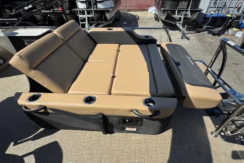 Slide: The Image of Luxurious seating on 2026 Barletta Cabrio 24UE pontoon boat with cup holders and tan upholstery. - 81