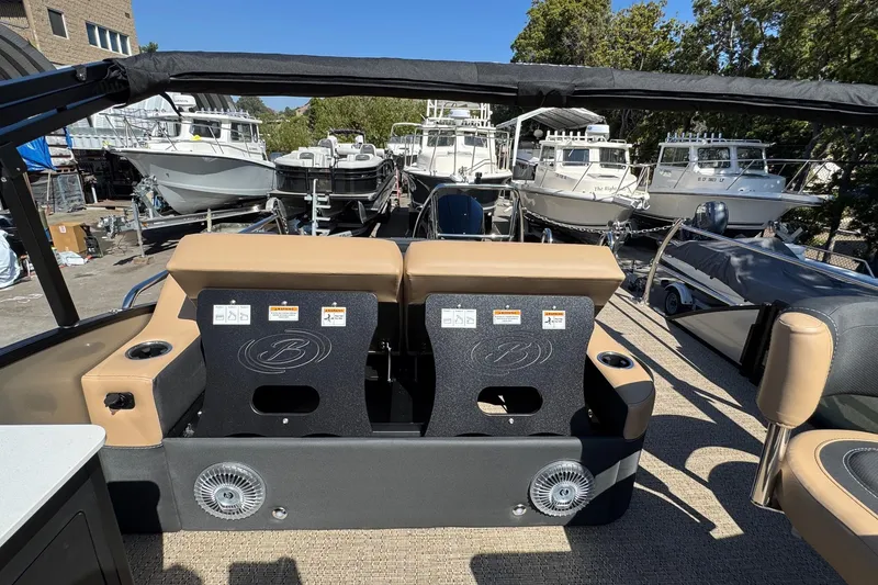 Slide: The Image of 2026 Barletta Cabrio 24UE pontoon boat interior with seating and cup holders. - 82