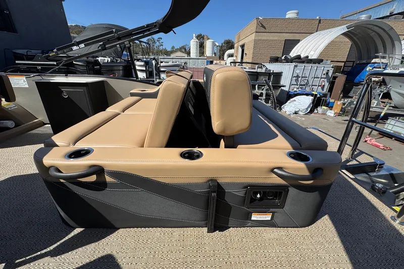 Slide: The Image of 2026 Barletta Cabrio 24UE boat seating with cup holders and tan upholstery. - 84