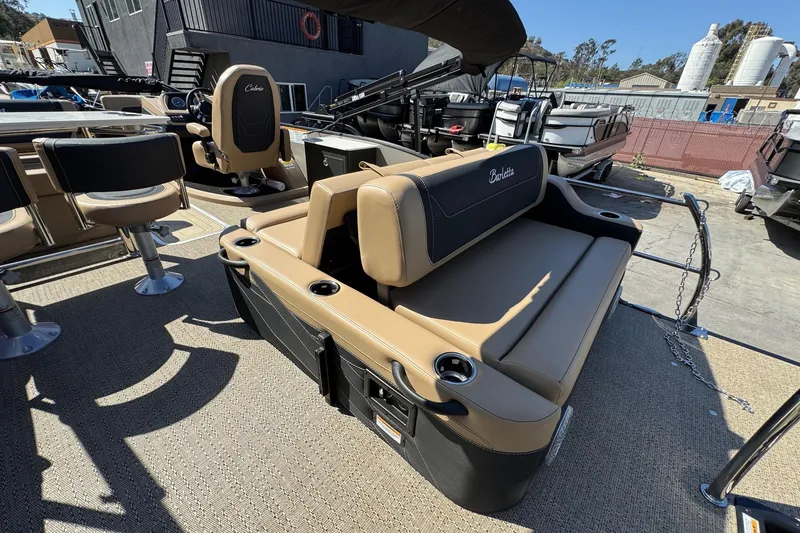 Slide: The Image of 2026 Barletta Cabrio 24UE pontoon boat with tan seating and cup holders. - 85