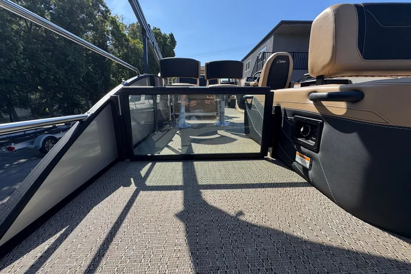 Slide: The Image of 2026 Barletta Cabrio 24UE pontoon boat interior with seating and glass gate. - 87