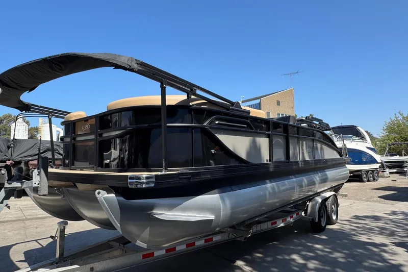 Slide: The Image of 2026 Barletta Cabrio 24UE pontoon boat on trailer, featuring a Mercury outboard motor. - 9