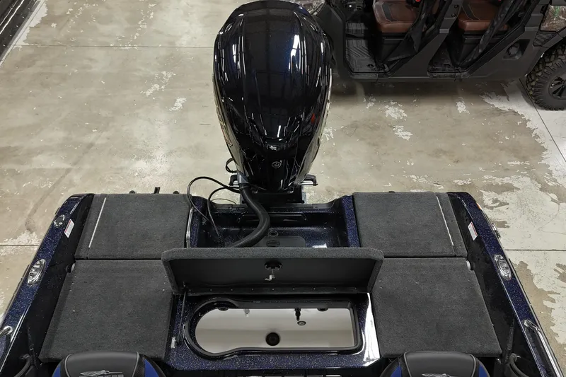 Slide: The Image of 2025 Skeeter Solera 189 boat interior with motor, viewed from above in a showroom. - 10