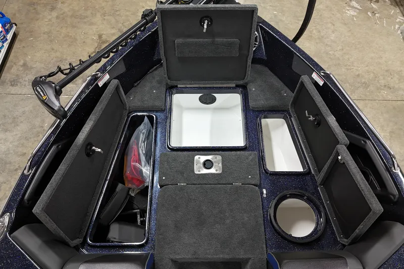 Slide: The Image of 2025 Skeeter Solera 189 boat interior with open storage compartments and trolling motor. - 13