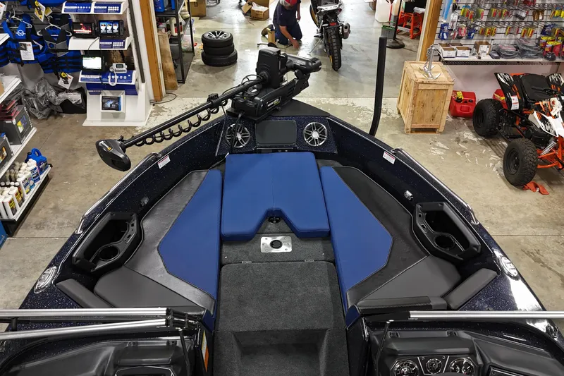 Slide: The Image of 2025 Skeeter Solera 189 boat interior with blue seating and advanced equipment in a workshop. - 14