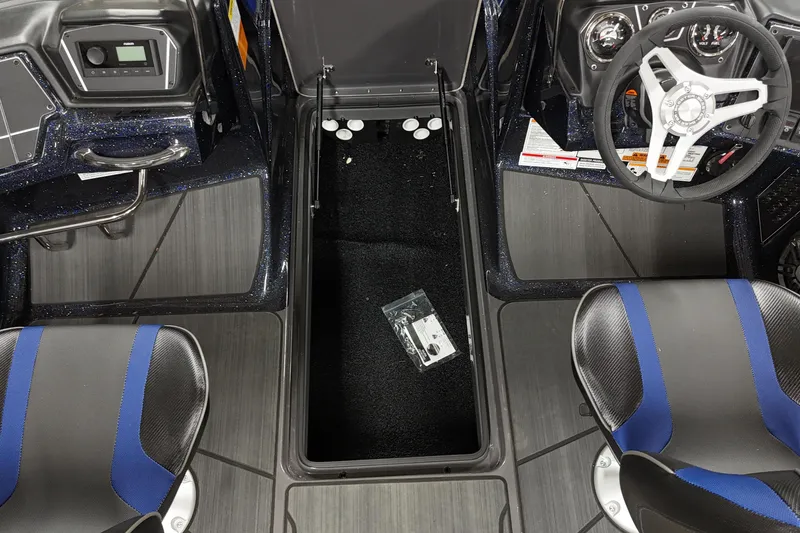 Slide: The Image of 2025 Skeeter Solera 189 boat interior with steering wheel, seats, and storage compartment. - 15