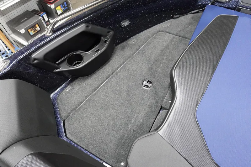 Slide: The Image of 2025 Skeeter Solera 189 boat interior with carpeted flooring and storage compartment. - 20