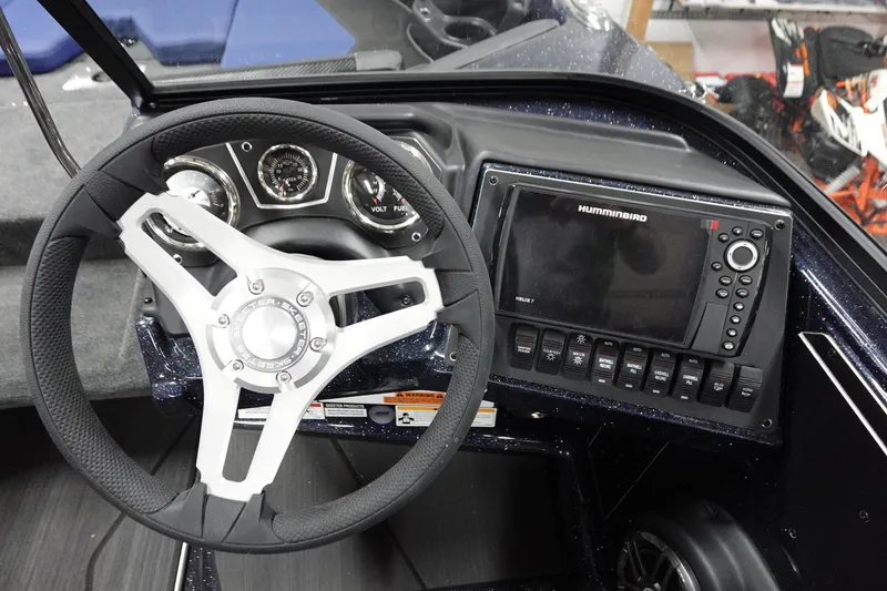 Slide: The Image of 2025 Skeeter Solera 189 dashboard with steering wheel and Humminbird Helix 7 display. - 29