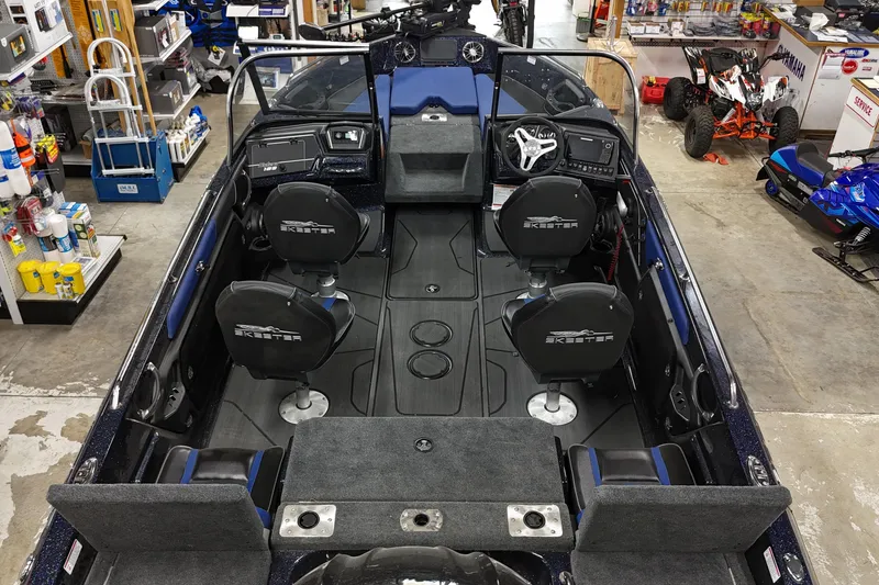 Slide: The Image of 2025 Skeeter Solera 189 boat interior with seating and controls in a showroom. - 3