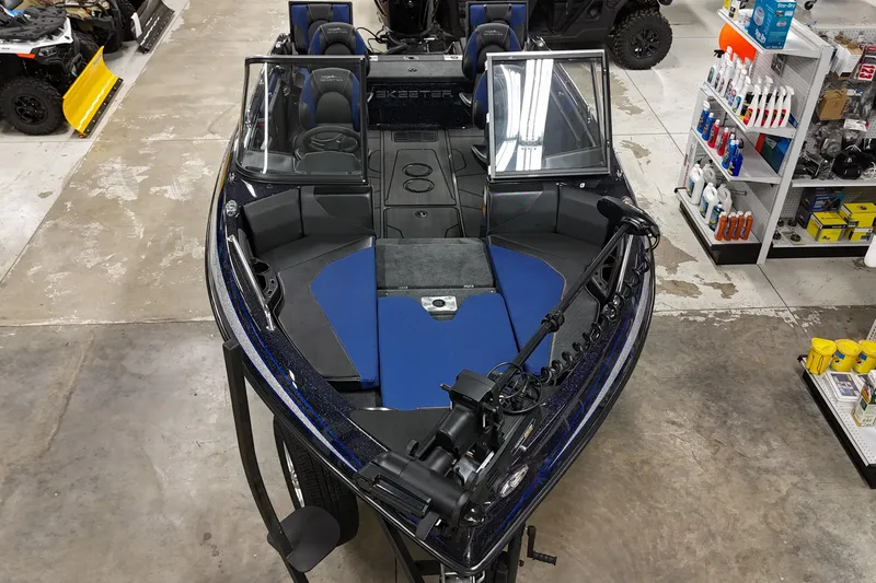Slide: The Image of 2025 Skeeter Solera 189 boat in showroom, featuring blue and black interior design. - 4