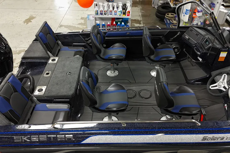 Slide: The Image of 2025 Skeeter Solera 189 boat interior with six blue and black seats, showroom display. - 8