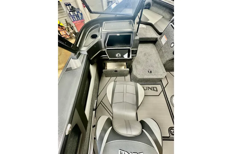 Slide: The Image of 2026 Lund 1875 Crossover XS boat interior with seating and storage compartments. - 10