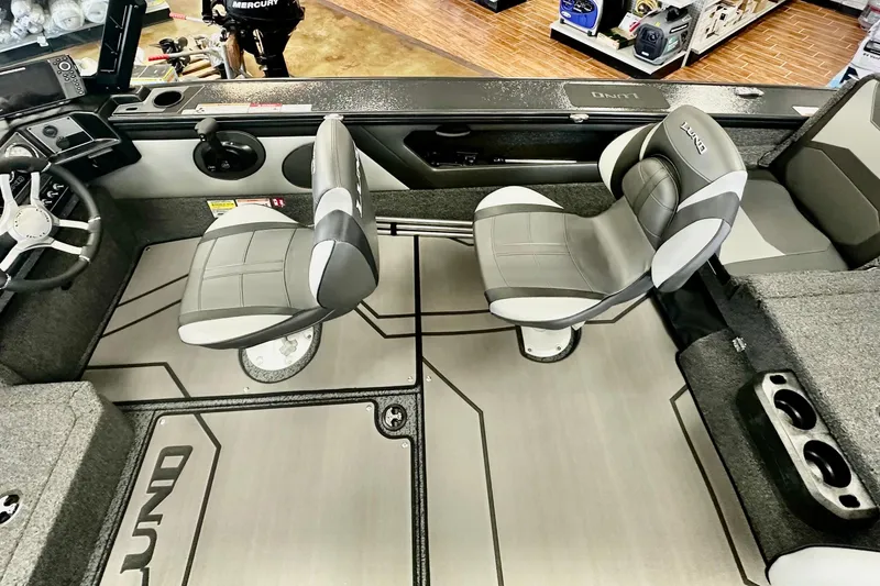 Slide: The Image of 2026 Lund 1875 Crossover XS boat interior with modern seating and steering wheel. - 11