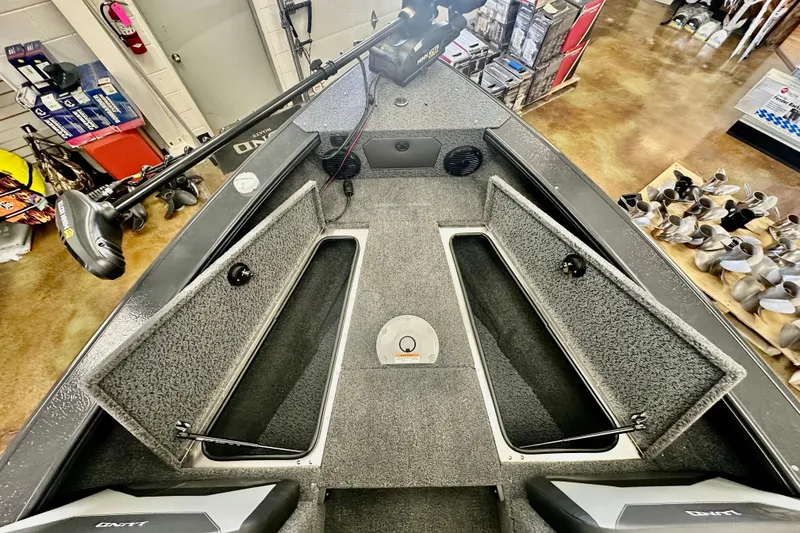 Slide: The Image of 2026 Lund 1875 Crossover XS boat interior with open storage compartments and equipment. - 16