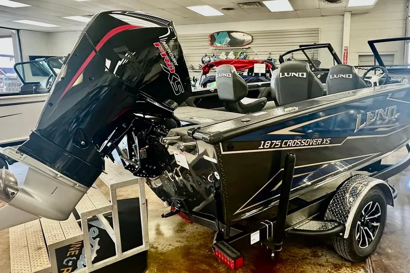 Slide: The Image of 2026 Lund 1875 Crossover XS boat with Mercury Pro XS engine in showroom. - 4