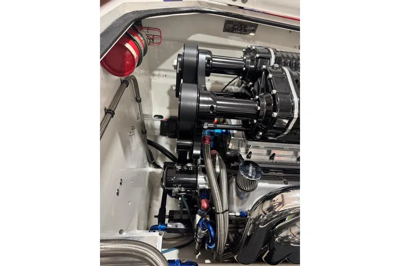 Slide: The Image of 1999 Skater 32B engine compartment with polished components and red fire extinguisher. - 10