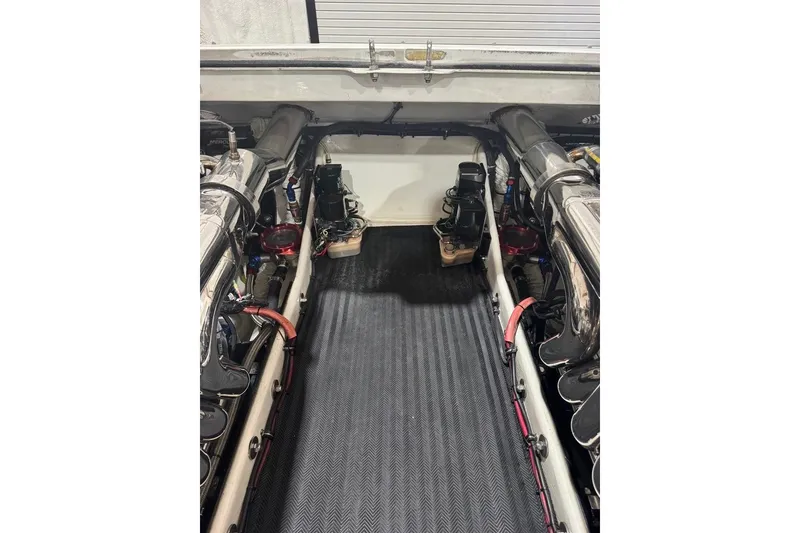 Slide: The Image of Engine compartment of a 1999 Skater 32B boat, showcasing dual engines and components. - 12