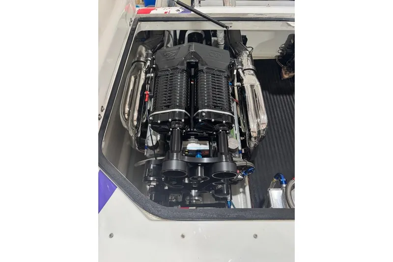 Slide: The Image of Engine compartment of a 1999 Skater 32B boat, featuring a high-performance engine. - 13
