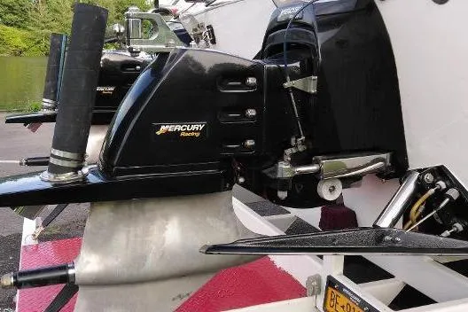 Slide: The Image of Outboard motor on a 1999 Skater 32B boat, featuring Mercury Racing branding. - 18