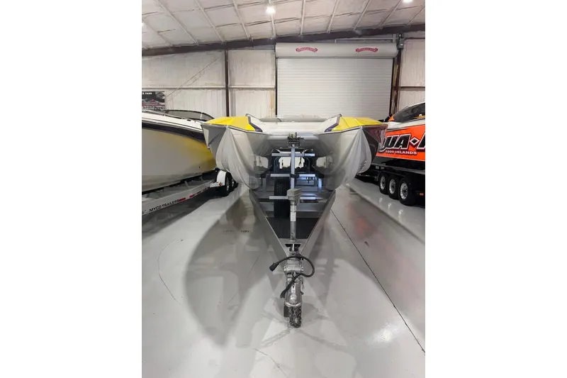 Slide: The Image of 1999 Skater 32B boat in storage, covered and on a trailer. - 5