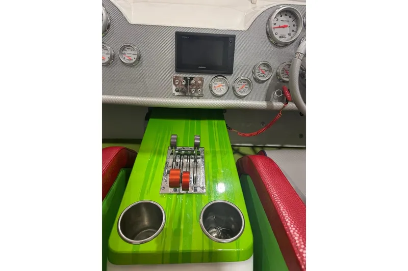 Slide: The Image of Dashboard of a 1999 Skater 32B with vibrant green controls and red seating. - 8