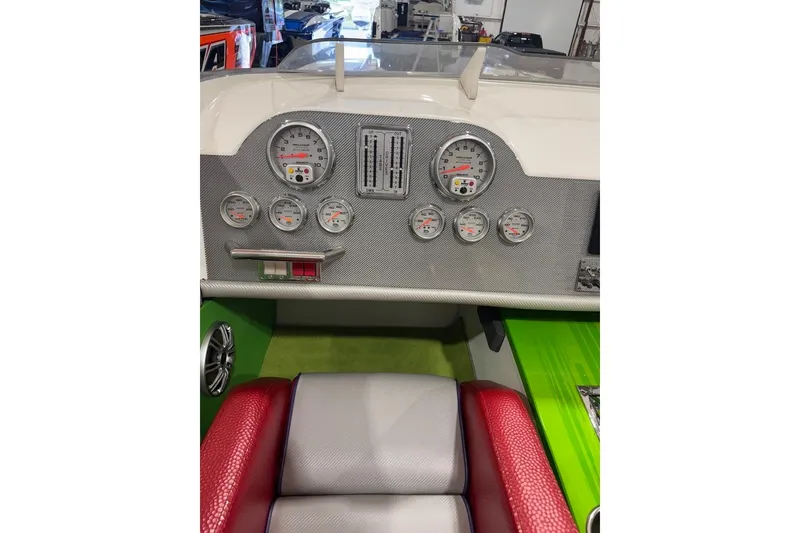 Slide: The Image of Dashboard of a 1999 Skater 32B boat with gauges and red seating. - 9