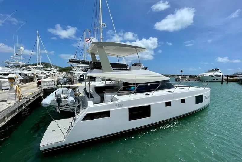 The Image of 2019 Nautitech 47 Power yacht docked in a sunny marina. - 1