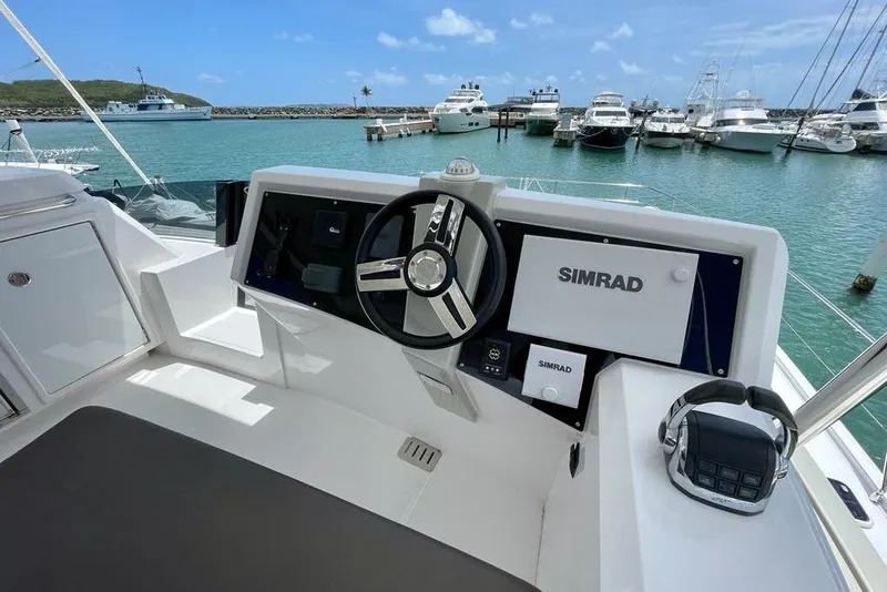 Slide: The Image of Helm of 2019 Nautitech 47 Power yacht with Simrad navigation system, docked in marina. - 14