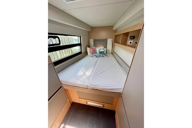 Slide: The Image of Cozy bedroom interior of 2019 Nautitech 47 Power yacht with modern design and window view. - 6