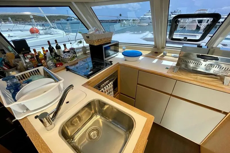 Slide: The Image of Modern kitchen interior on 2019 Nautitech 47 Power yacht, featuring sink and appliances. - 9
