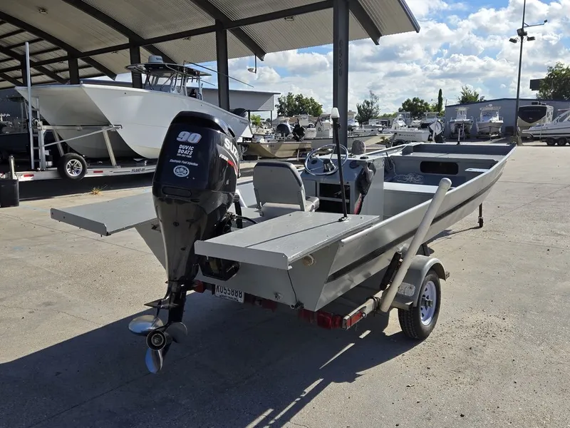 Slide: The Image of 1991 Alumaweld FLATBOAT with outboard motor on trailer. - 6