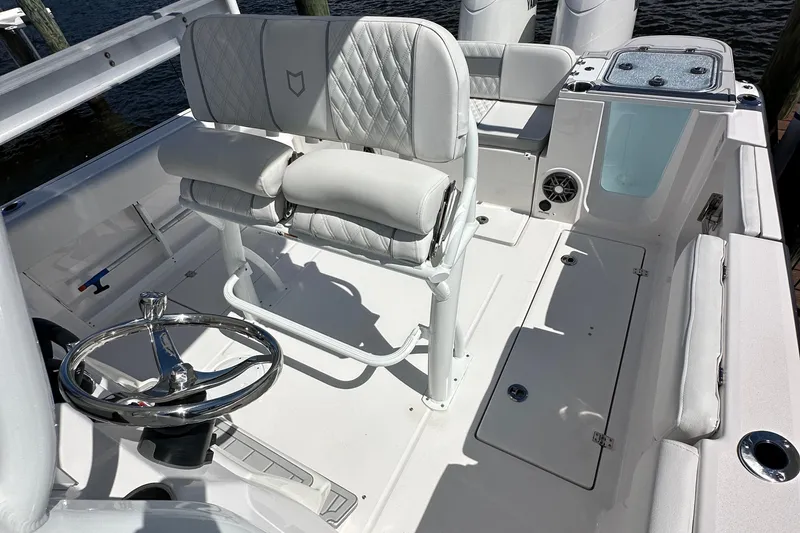 Slide: The Image of 2026 Sea Fox 268 Commander boat interior with seating and speaker, docked at marina. - 10
