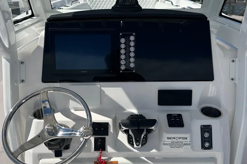 Slide: The Image of 2026 Sea Fox 268 Commander boat cockpit with Garmin navigation system and comfortable seating. - 11