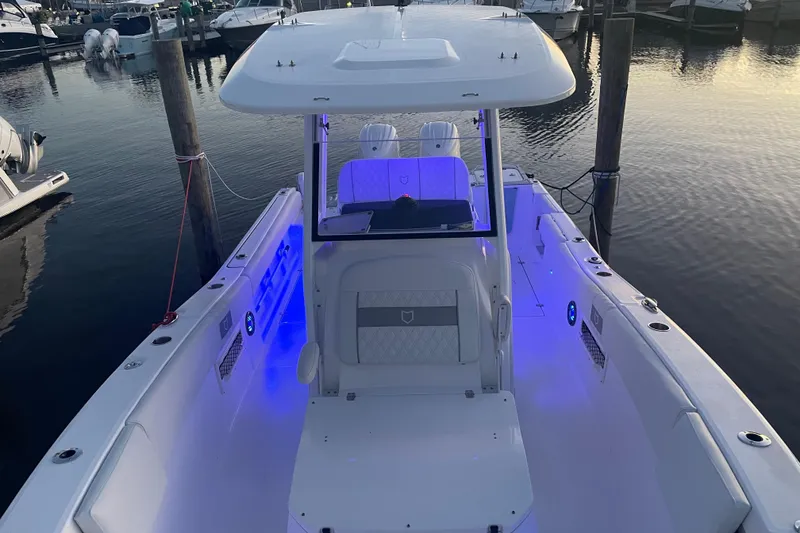 Slide: The Image of 2026 Sea Fox 268 Commander boat interior at marina, showcasing seating and storage. - 18