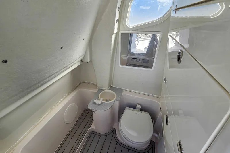 Slide: The Image of Interior of 2026 Sea Fox 268 Commander boat bathroom with toilet and window. - 21