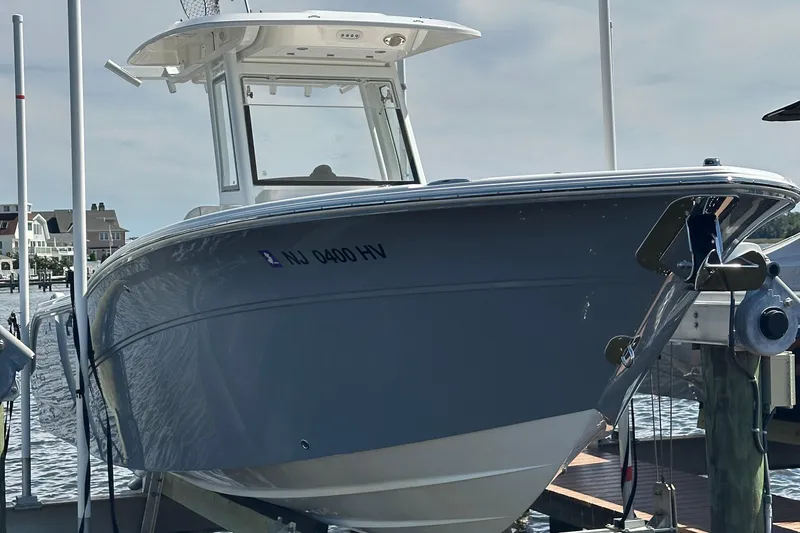 Slide: The Image of 2026 Sea Fox 268 Commander boat docked in marina, surrounded by watercraft. - 4