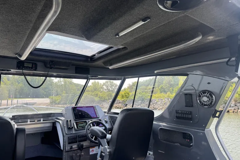 Slide: The Image of Interior of 2023 Extreme Boats 795 Game King, featuring modern dashboard and controls. - 13