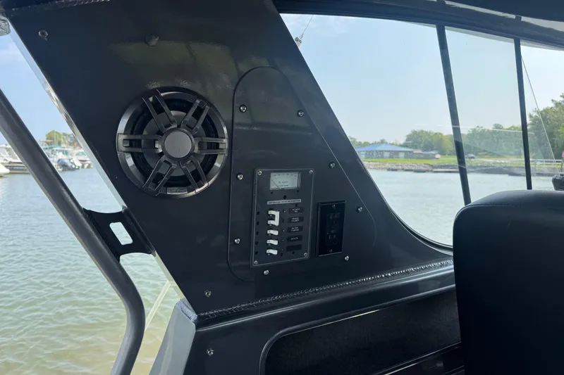 Slide: The Image of Interior view of 2023 Extreme Boats 795 Game King with speaker and control panel. - 14