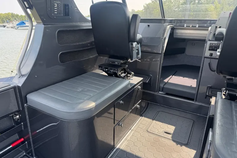 Slide: The Image of Interior of 2023 Extreme Boats 795 Game King, featuring seating and control panel. - 15