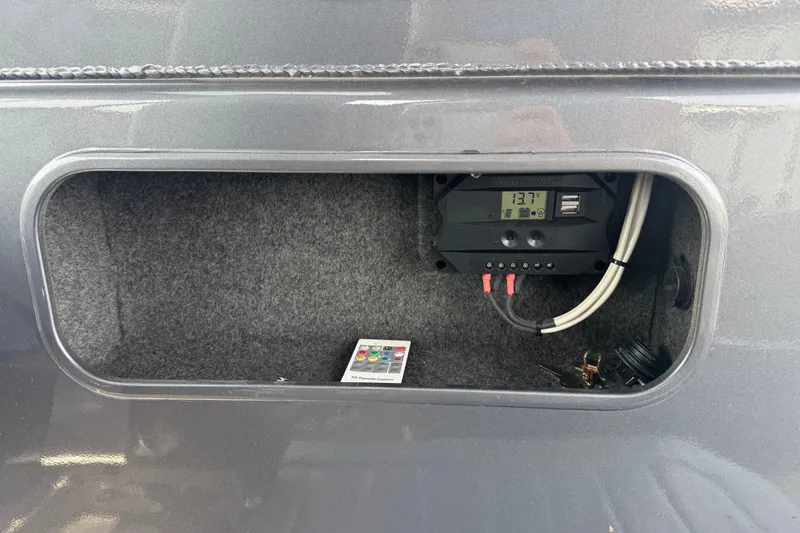 Slide: The Image of Control panel inside 2023 Extreme Boats 795 Game King, showing voltage and wiring. - 19