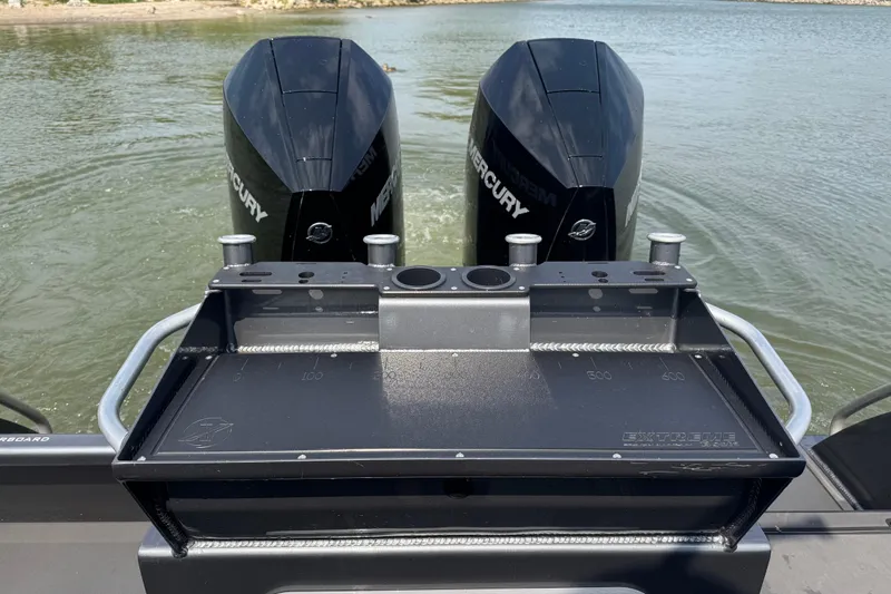 Slide: The Image of 2023 Extreme Boats 795 Game King with dual Mercury engines on water. - 21
