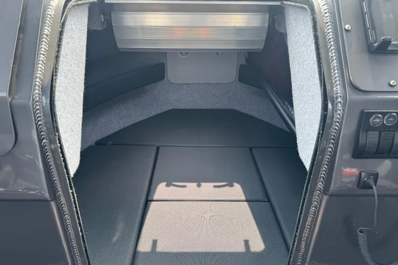 Slide: The Image of Interior cabin of 2023 Extreme Boats 795 Game King, featuring cushioned seating and storage. - 24