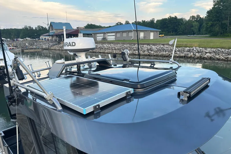 Slide: The Image of 2023 Extreme Boats 795 Game King with solar panel and radar, docked near marina. - 30