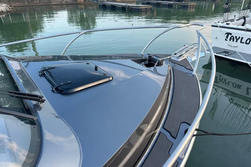 Slide: The Image of 2023 Extreme Boats 795 Game King, sleek design, docked in marina. - 31