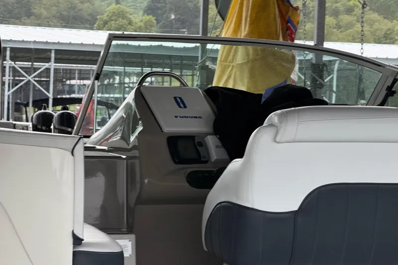 Slide: The Image of 2001 Cruisers Yachts 3672 Express interior with white seating and control panel. - 15