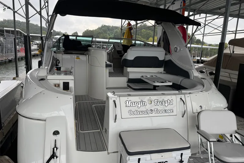 Slide: The Image of 2001 Cruisers Yachts 3672 Express docked, featuring spacious seating and sleek design. - 16