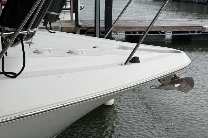 Slide: The Image of 2001 Cruisers Yachts 3672 Express bow with anchor, docked on calm water. - 17